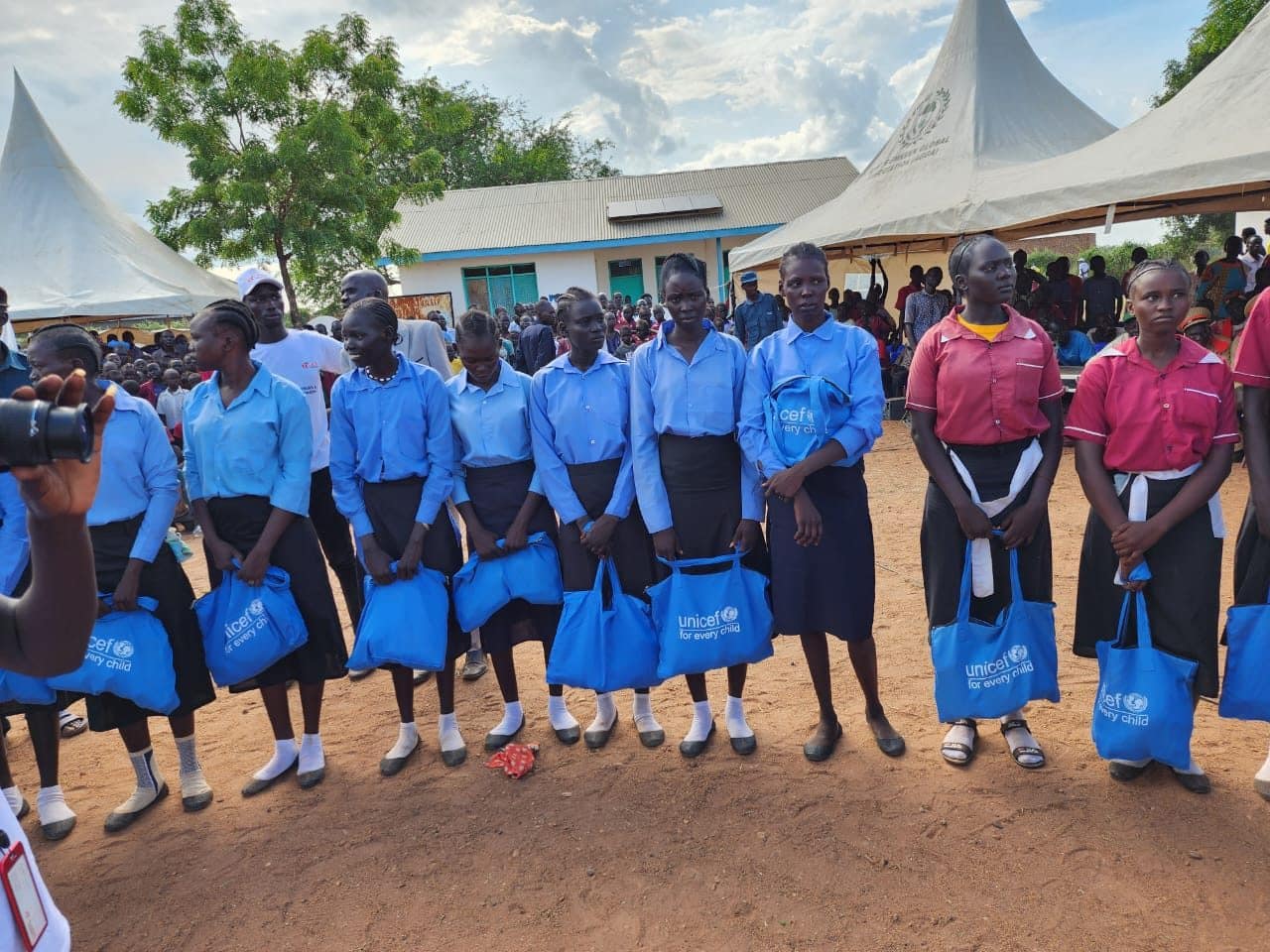 Schoolgirls receiving support kits